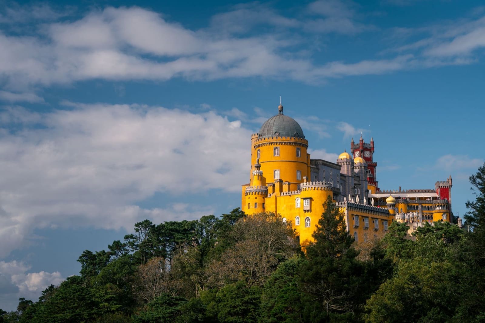Stunning view of the colorful Pena Palace in Sintra, Portugal on a sunny day.